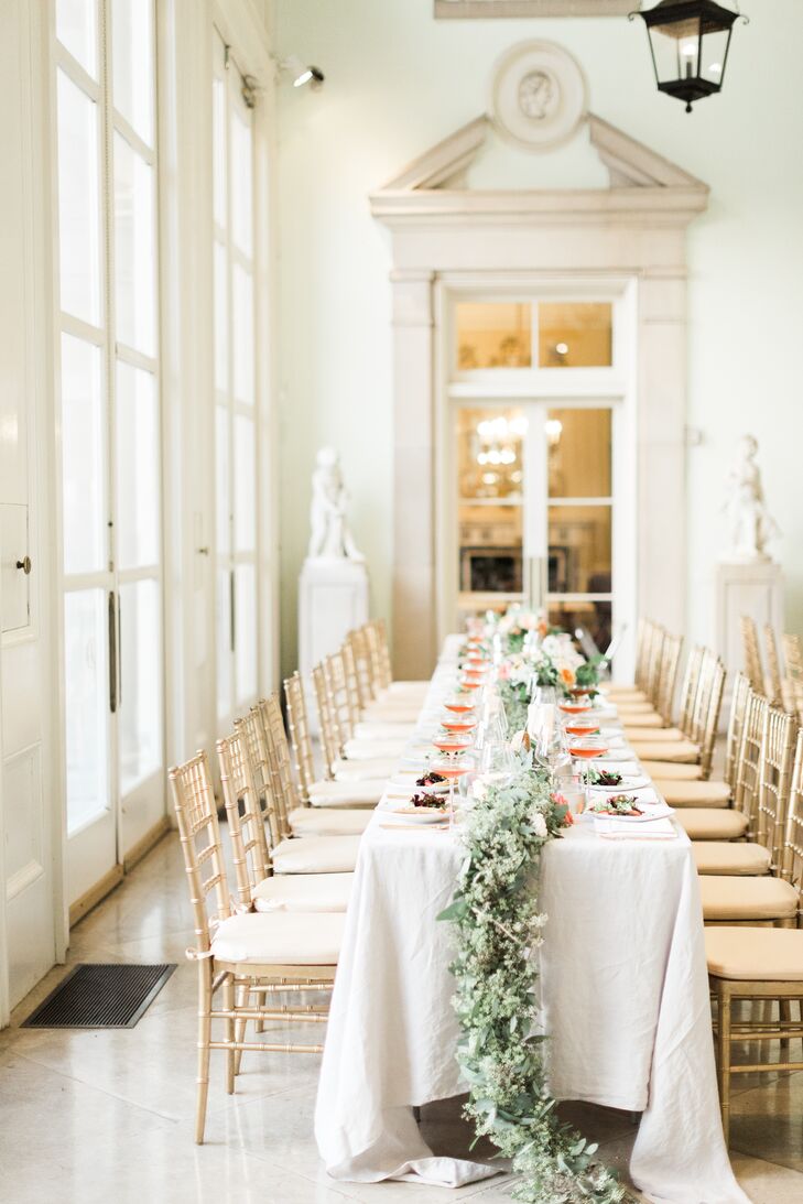 Rows of gold chiavari chairs lined long tables in the mansion's loggia for the reception dinner.