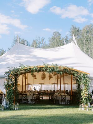 Wooden Arch in at Entrance of Tented Reception Adorned With Greenery