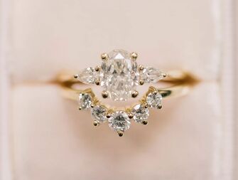 vintage-looking three-stone oval engagement ring 