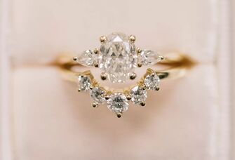 vintage-looking three-stone oval engagement ring 
