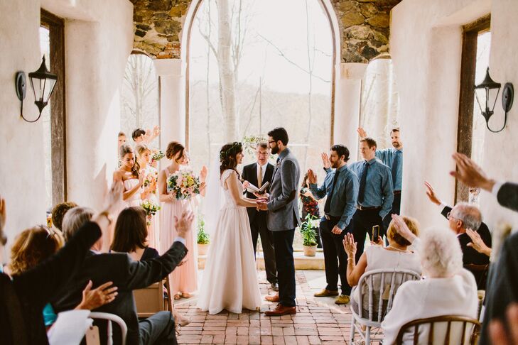 Kira's uncle, Pastor Doug Strong, conducted the wedding ceremony, and asked guests to stretch their hands out of love toward the bride and groom.