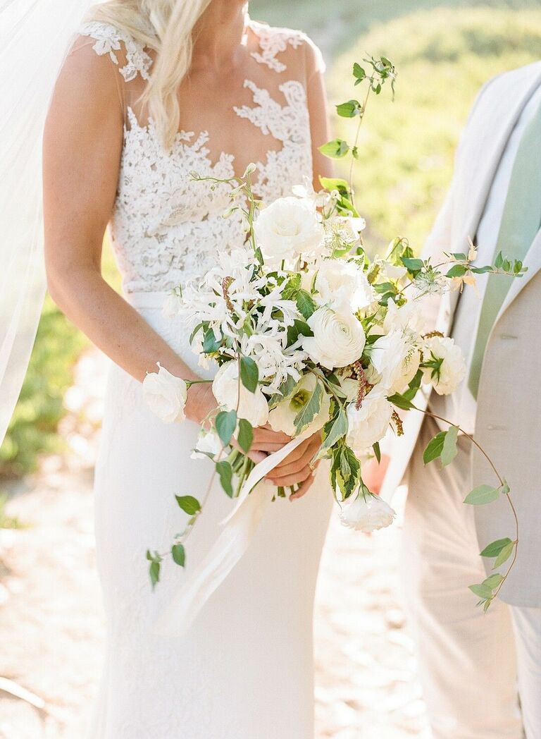 Cascading white bouquet with roses and ranunculus