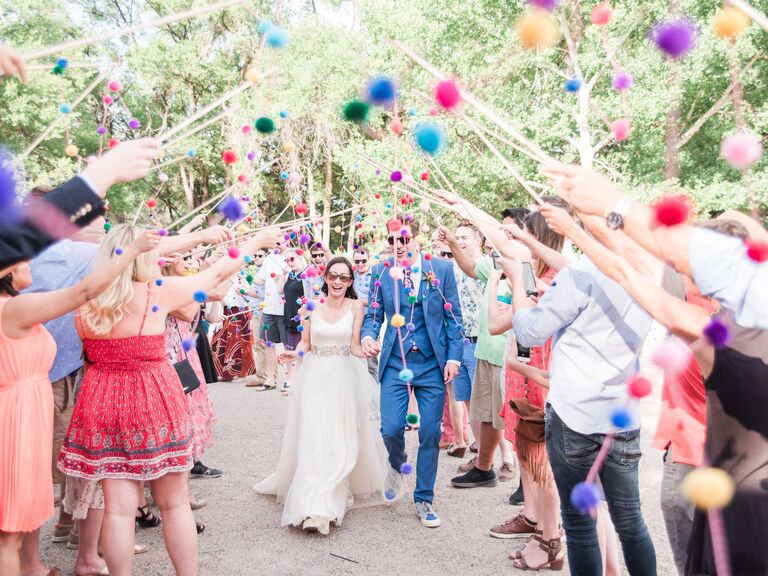 Colorful pom pom sticks used as a wedding send-off. 