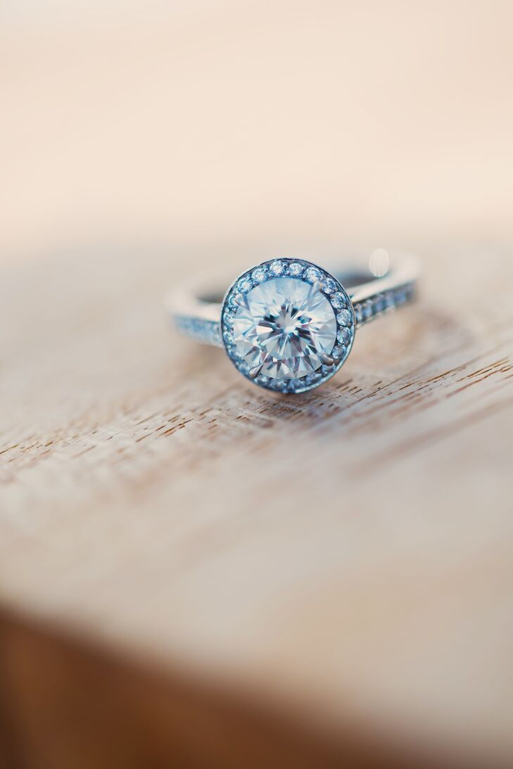When Andrew proposed to Galin, in full clown gear, he presented her with a round cut diamond in a halo setting from Tiffany & Co.