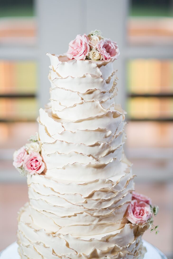 The ivory wedding cake stood four tiers high, covered in textured buttercream frosting. The cake was made out of fresh, organic ingredients picked out by Elon herself, created by The End Dessert Company. Two layers of the cake were dark chocolate with strawberry whipped buttercream, one layer was strawberry cake with matching buttercream, and the final layer was an orange cake with fresh lemon curd and vanilla buttercream.