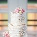 The ivory wedding cake stood four tiers high, covered in textured buttercream frosting. The cake was made out of fresh, organic ingredients picked out by Elon herself, created by The End Dessert Company. Two layers of the cake were dark chocolate with strawberry whipped buttercream, one layer was strawberry cake with matching buttercream, and the final layer was an orange cake with fresh lemon curd and vanilla buttercream.