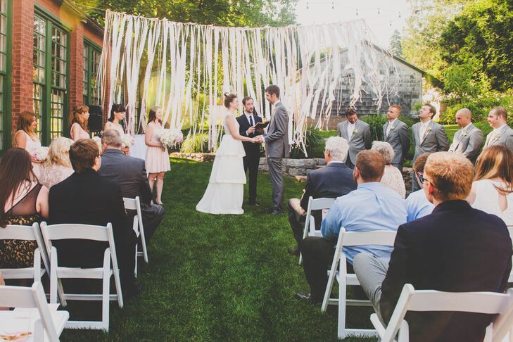 Katie and Justin were married on the lawn at the Lace Factory in Deep River, Connecticut. The couple joined at the ceremony in front of the draped gold, pink and white ribbon backdrop.