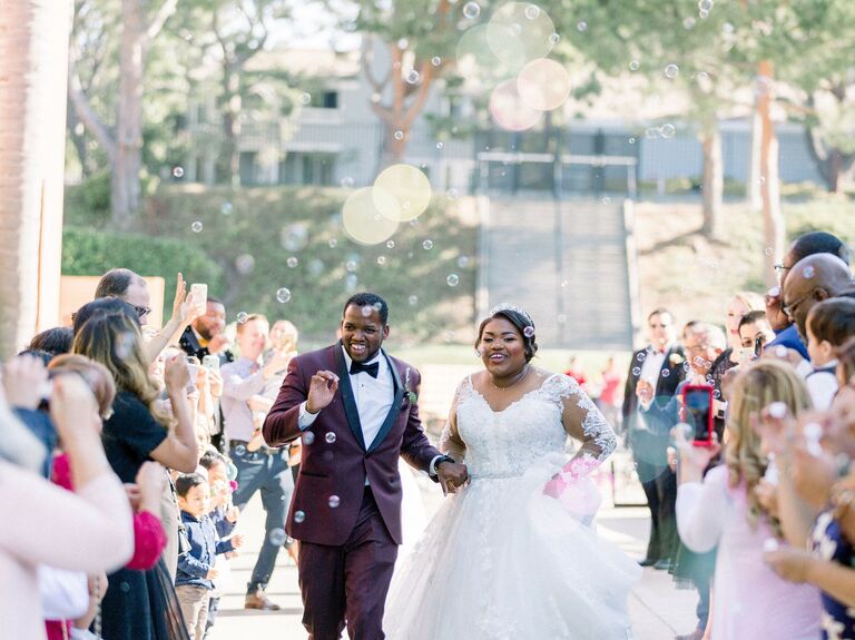 Couple leaves ceremony and has a bubble wedding exit. 