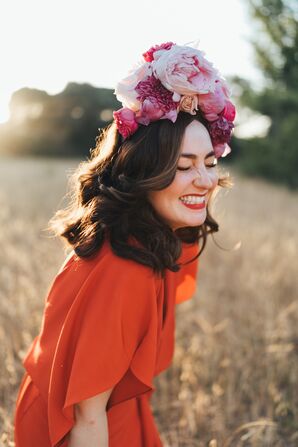 Bride Smiling in a Field While Wearing Pink Flower Crown