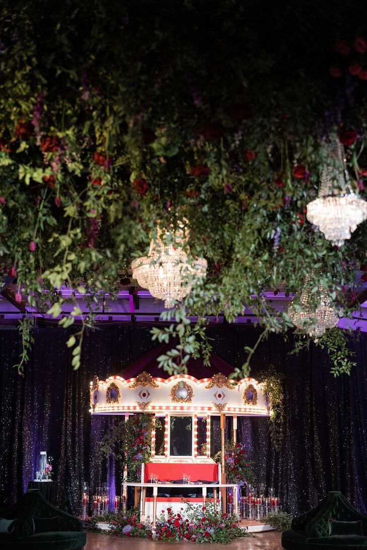 Hanging Greenery, Crystal Chandeliers and Carousel at Carnival-Themed Wedding