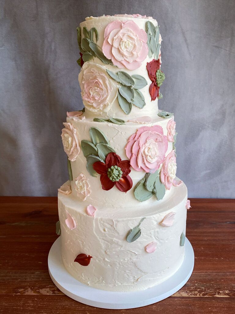 Three tier white bridal shower cake with icing flowers and leaves