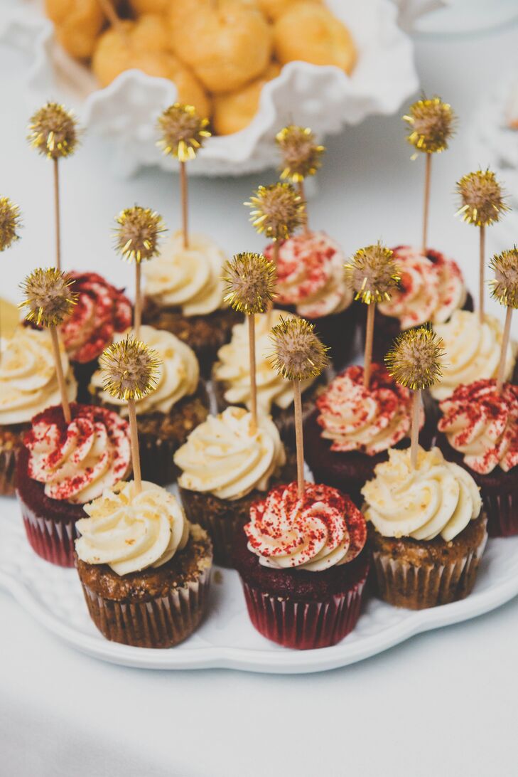 An assortment of carrot cake and red velvet cupcakes were served for dessert, in addition to the white vanilla wedding cake. " We kept the wedding cake simple with just vanilla cake and frosting, but we also had mini cupcakes to represent our favorite desserts in our early dating," Katie says. "We couldn't afford to order desserts at restaurants, so we would stop at the grocery store on the way home and I would get a piece of carrot cake and Justin would get a piece of red velvet cake, which were our cupcake flavors."