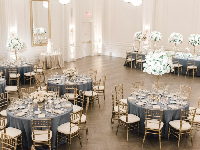Modern indoor reception space with gold chairs and white flowers at The Adolphus wedding venue in Dallas, Texas