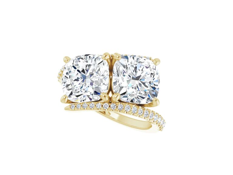 cushion cut diamond two stone ring in yellow gold setting