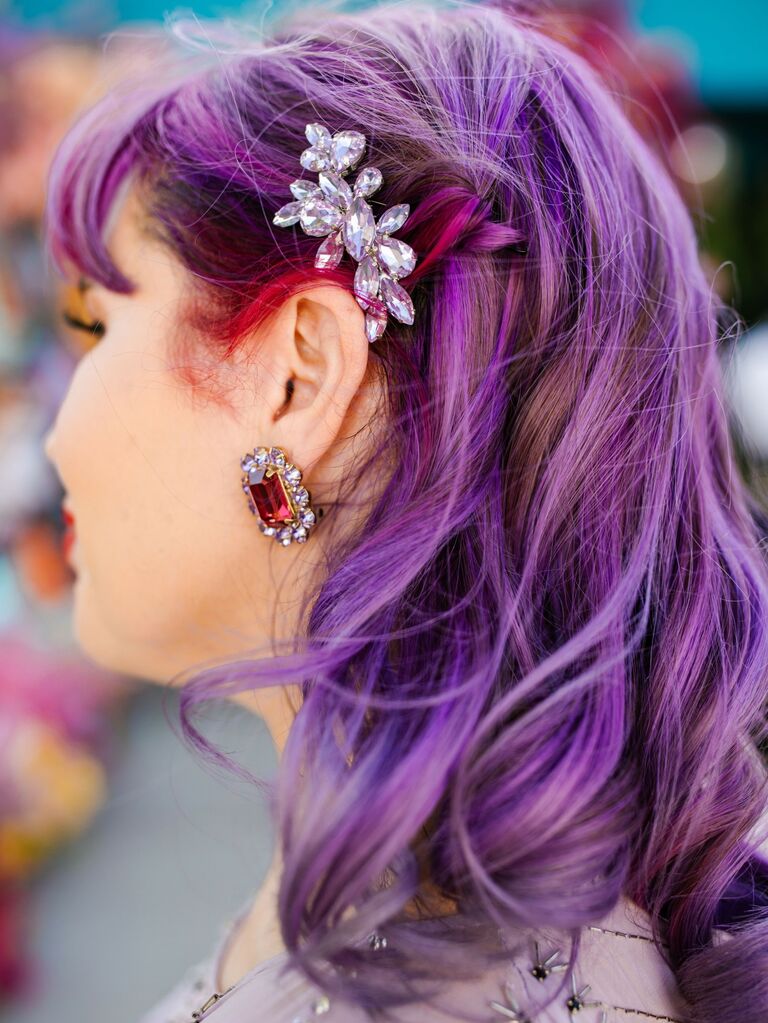 Beautiful bright purple hair softly curled and pinned back with dazzling clips. 