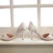 Katie wore a pair of ivory open-toed shoes accented with crystals at the top, which were purchased from Nordstroms.
