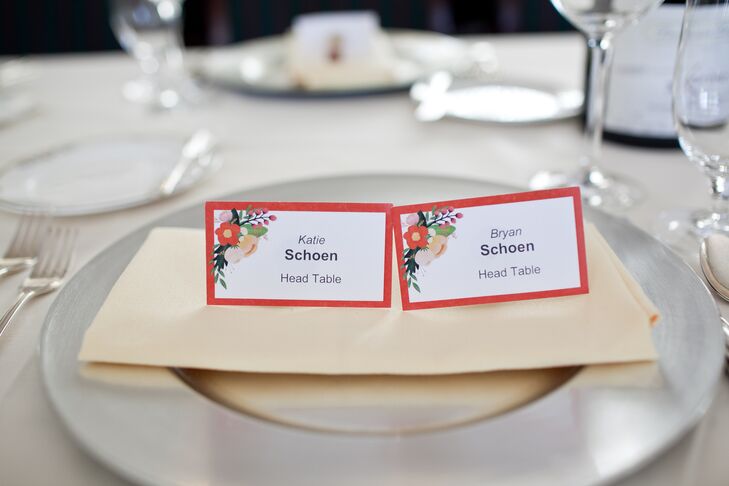 White escort cards were bordered with red, and had a floral graphic in the upper left corner.
