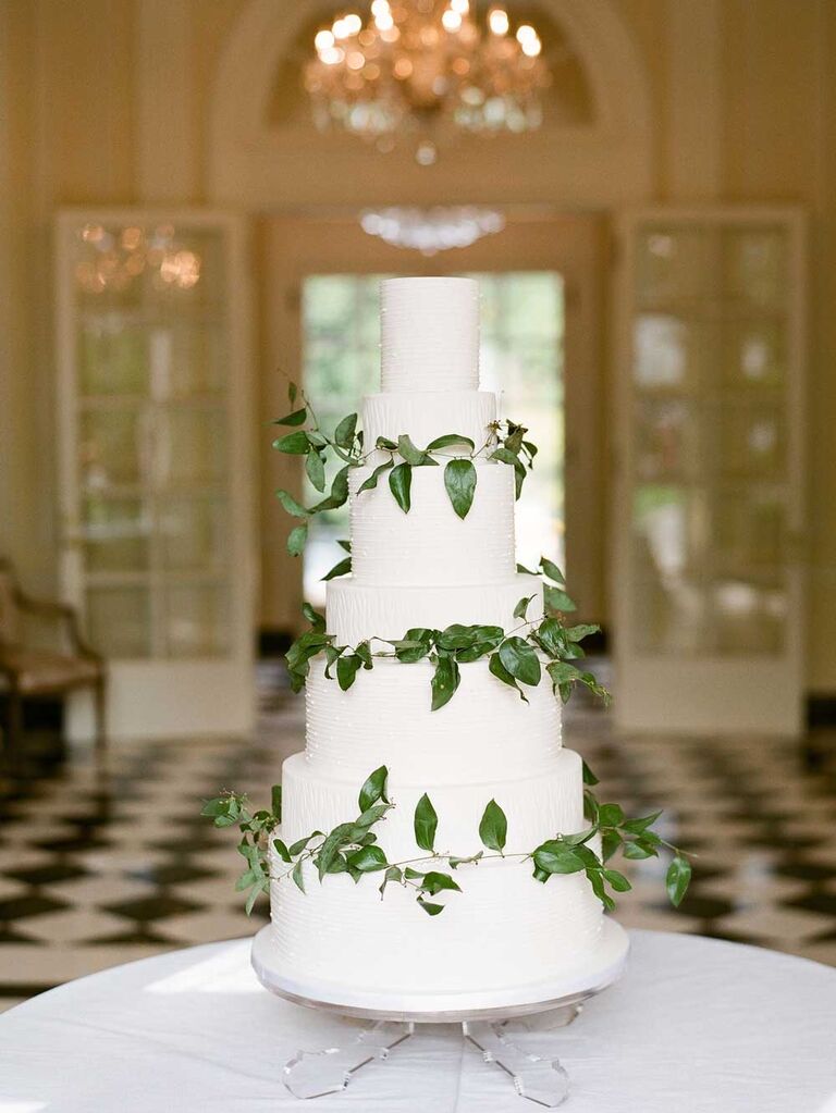 White wedding cake with green leaf garlands