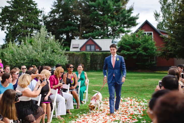 Hannah and Ed’s faithful pup made an appearance during the ceremony, much to the delight of guests, joining Ed as he made his way down the rose-petal-adorned aisle. Keeping with the wedding’s color scheme, their canine companion sported a coral leash and harness.