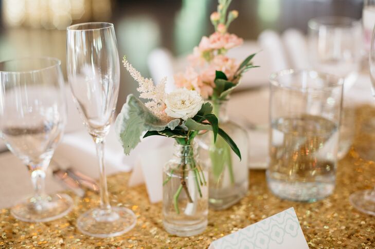 The wedding’s color palette was predominately mint and gold, and Katharine and Nate used flowers to add pink to the decor. For the reception, the pair dotted the glam tablecloths with bud vases with an assortment of seasonal blooms in soft blush and playful pink.
