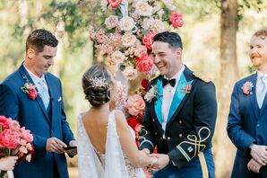Groom in "Mess Dress" Military Formalwear and Bride Laugh at Floral Altar