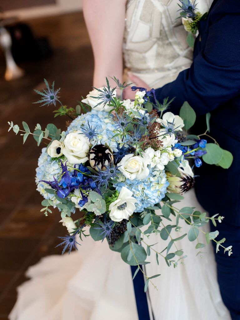 Celestial wedding bouquet with white, blue and indigo florals with greenery sprigs