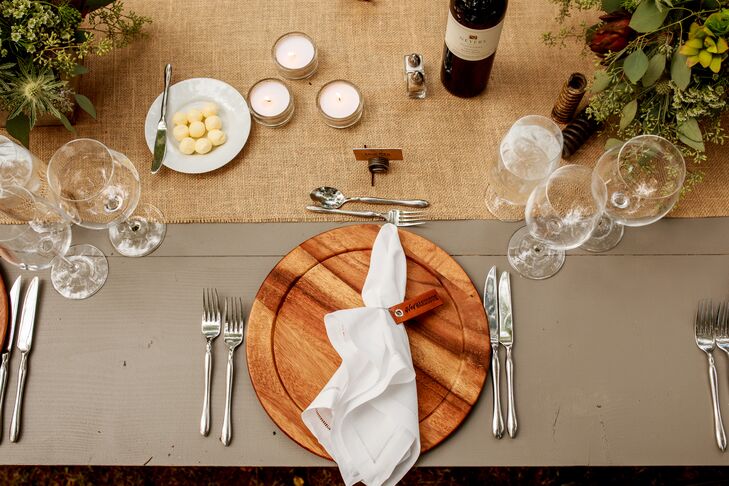 The chic place settings incorporated elegant wood plates and a burlap table runner for a modern rustic vibe. For favors, Dave and Chad gave their guests custom leather keychains that read either "Hey Handsome" or "Hello Gorgeous"--and they also doubled as napkin rings!