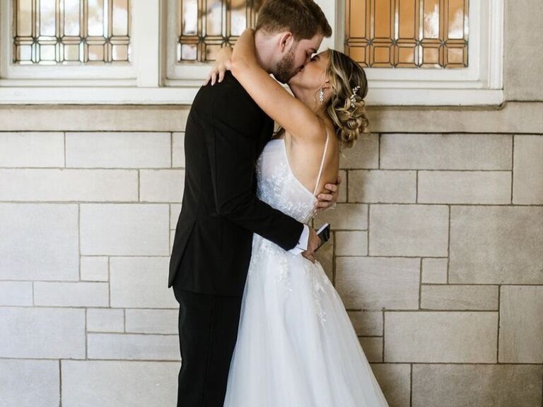 Bride and groom embrace on their wedding day. 
