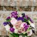 Elizabeth carried pink peonies, white hydrangeas, purple lisianthus and purple sweet peas in her bold bouquet. She loved how it added a pop of color to her simple Stella York ball gown wedding dress.
