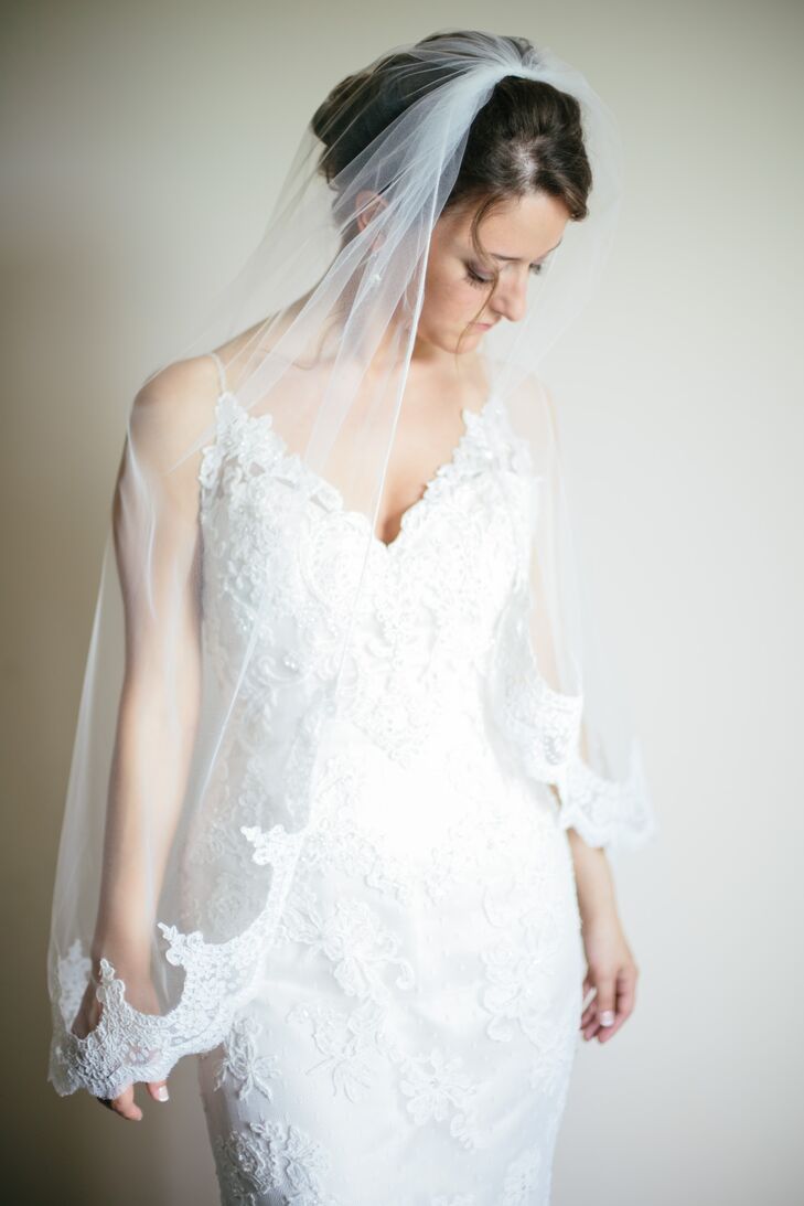 Nicole, a lover of all things romantic and lace, opted for a Casablanca Bridal v-neck lace overlay gown. Her lace edged fingertip veil sat atop her perfectly coiffed bridal updo.
