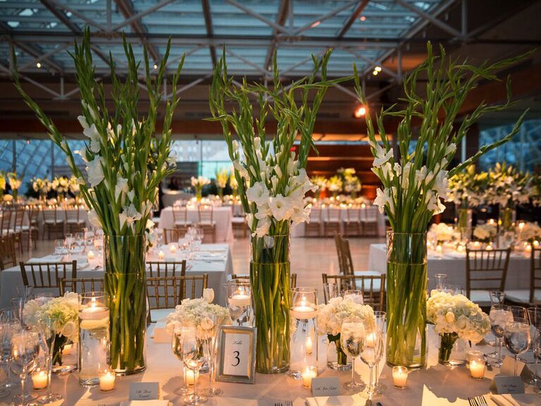 Tall white gladiolus floral centerpieces at modern wedding reception