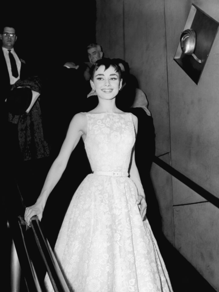 Audrey Hepburn in a white floral bridal-inspired gown at the Academy Awards