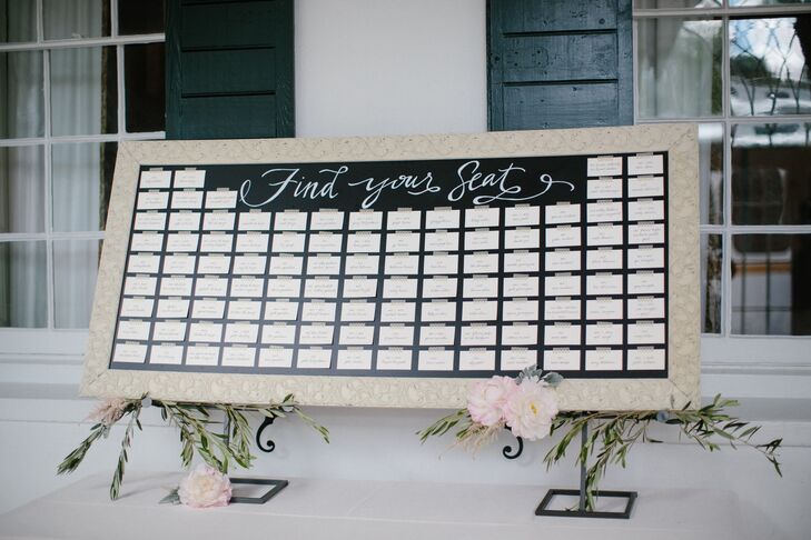 Nina's family friend, Cindy Carney, created chic ivory and gold escort cards. They were displayed on a white-framed chalkboard that was decorated with olive branches and pink peonies. Once guests got to their seats, they were greeted with a funny photo of themselves in a Polaroid format. "It was a labor of love finding and selecting all the photos, but it was so much fun to see the delight on our guests’ faces when they saw their photos," Nina says. "It was also a great talking point for guests to get to know one another."