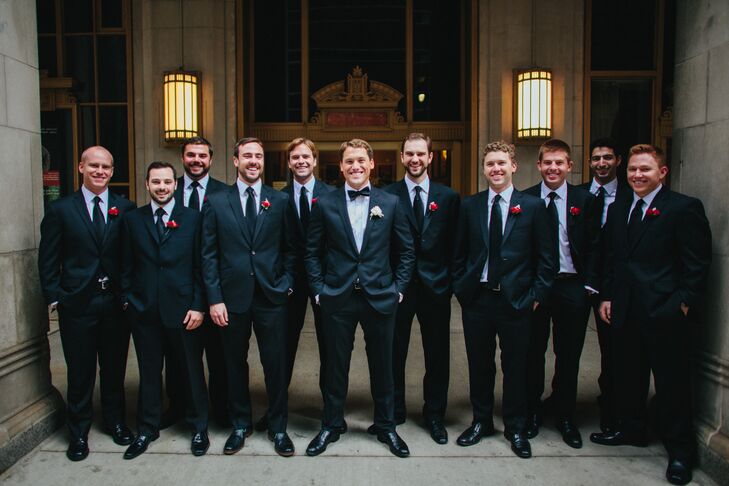 Each groomsman paired a classic black tuxedo with red ranunculus and dusty miller boutonnieres. Dave set himself apart by completing his look with a single white ranunculus on his lapel.