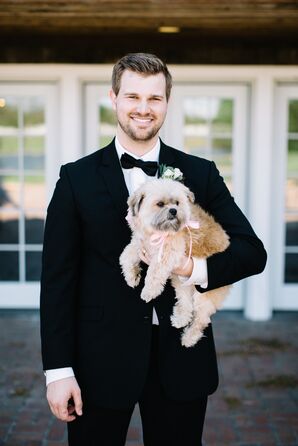 Groom in Classic Black Tuxedo with Puppy