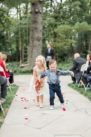 Flower Girl and Ring Bearer Walking Down Outdoor Aisle with Rose Petals