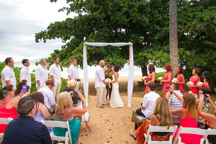 The wedding arch was built with bamboo stakes and wrapped with white linens.