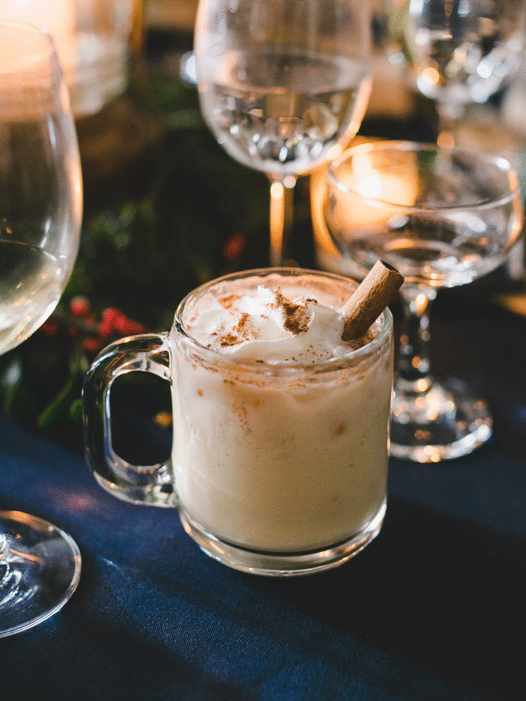 Eggnog with a cinnamon stick as a winter wedding signature drink.