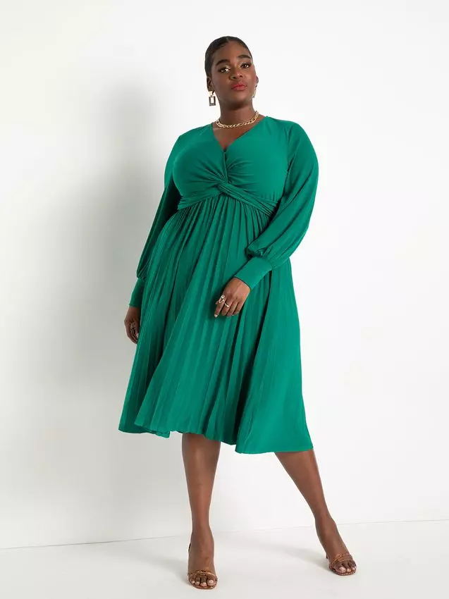 A model shows off this gorgeous knotted gown with long sleeves and a pleated skirt.