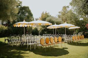 Outdoor Ceremony Space on Lawn, Orange and Yellow Chairs and Parasol Umbrellas Overhead