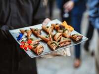 sever holding mini samosas on tray