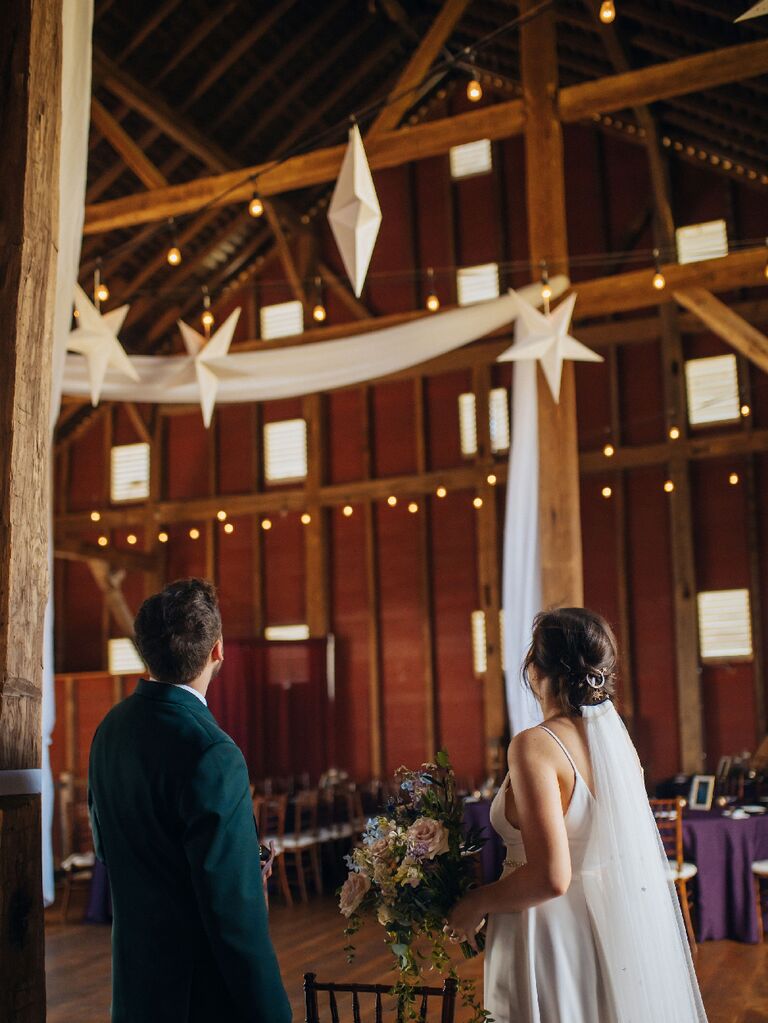 Bride and groom looking up at suspended stars at celestial wedding