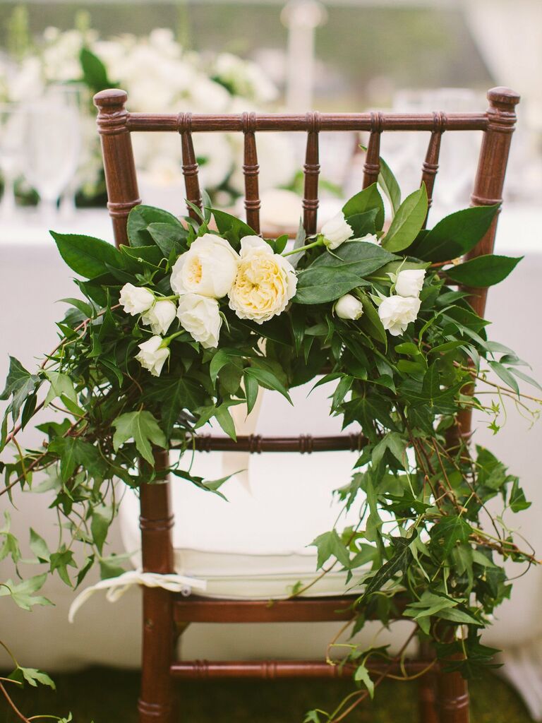 brown chiavari chair with floral swag of greenery and white flowers