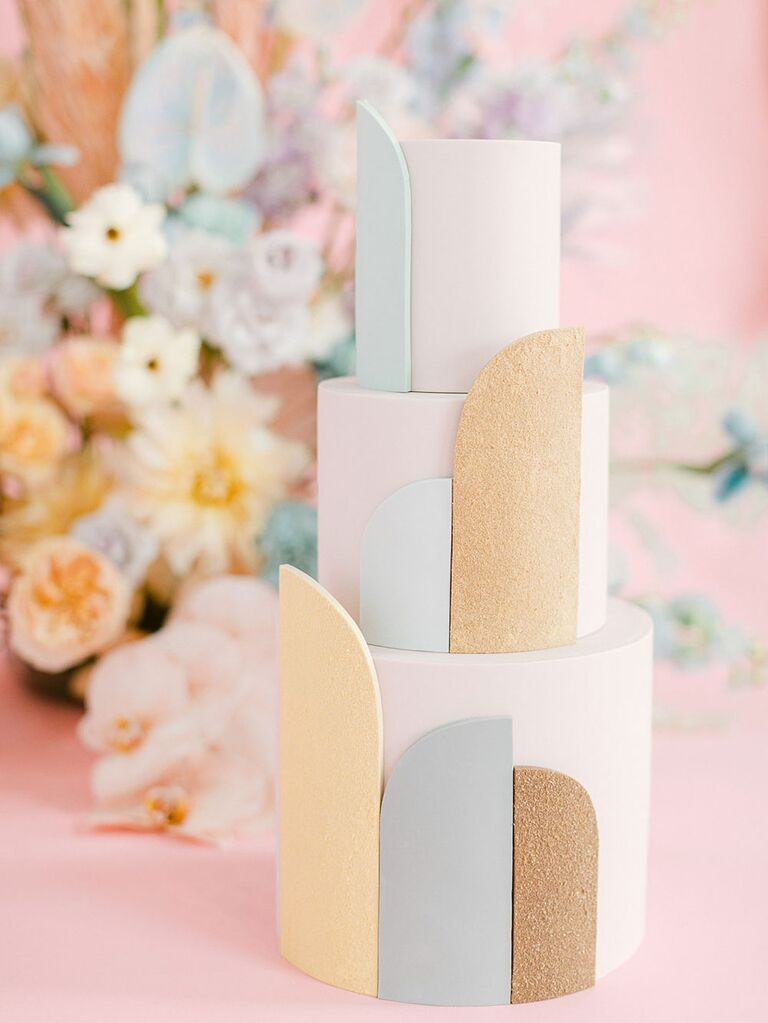 Three tier white bridal shower cake with gold glitter and pastel accents