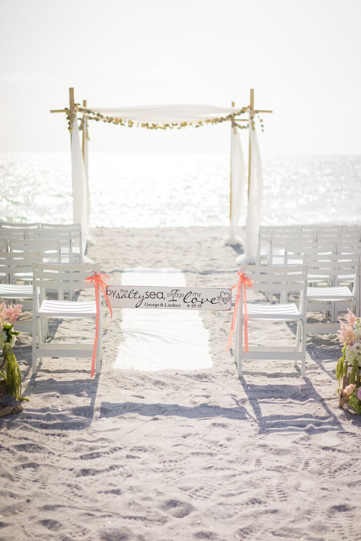 “The ocean has always been our favorite place. We grew to have many special moments together on the beach, including our engagement,” Lindsey says. “It was no question that we wanted to have our wedding near the sea.” The ocean was the focal point of their ceremony. They decorated the sand with only white folding chairs, a classic white runner and a few lush arrangements along the entrance. Each one was filled with blush peonies, green hydrangeas, white delphiniums, pink astilbes, white garden roses and pink roses.