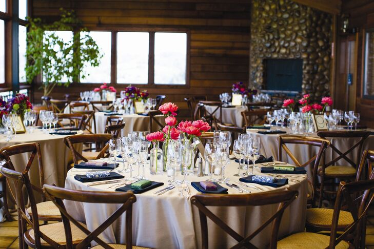 The elegantly simple table settings featured champagne tablecloths, navy napkins and clear bottles filled with single stems of peonies.
