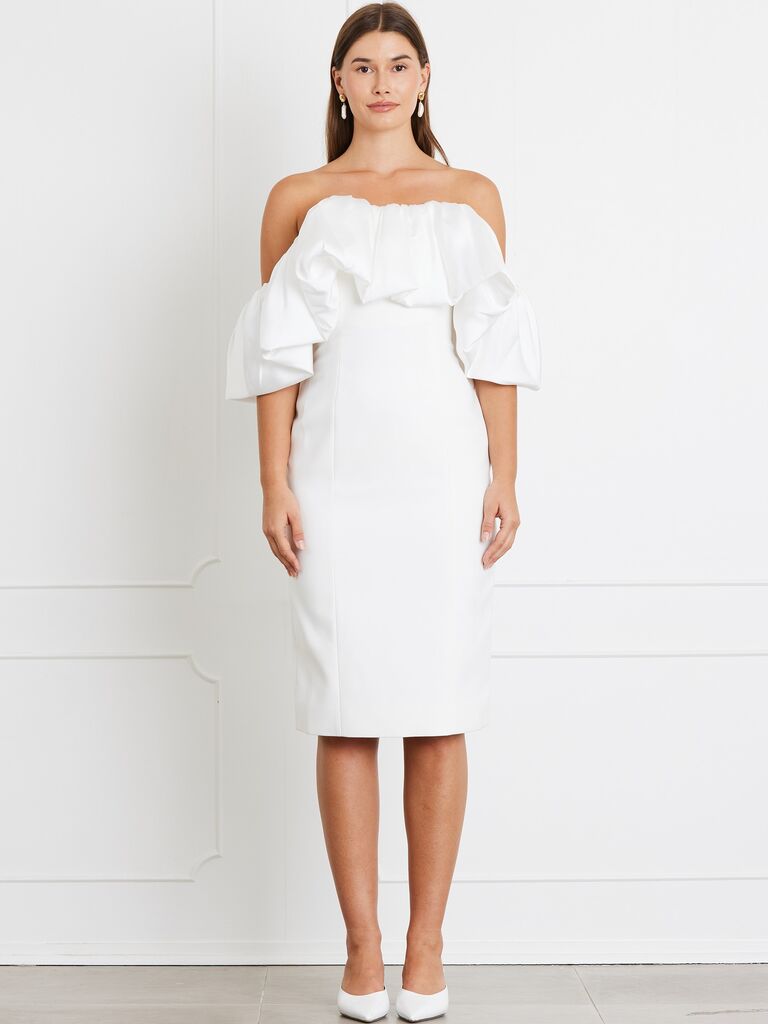 Bride wears a short off the shoulder white dress. 