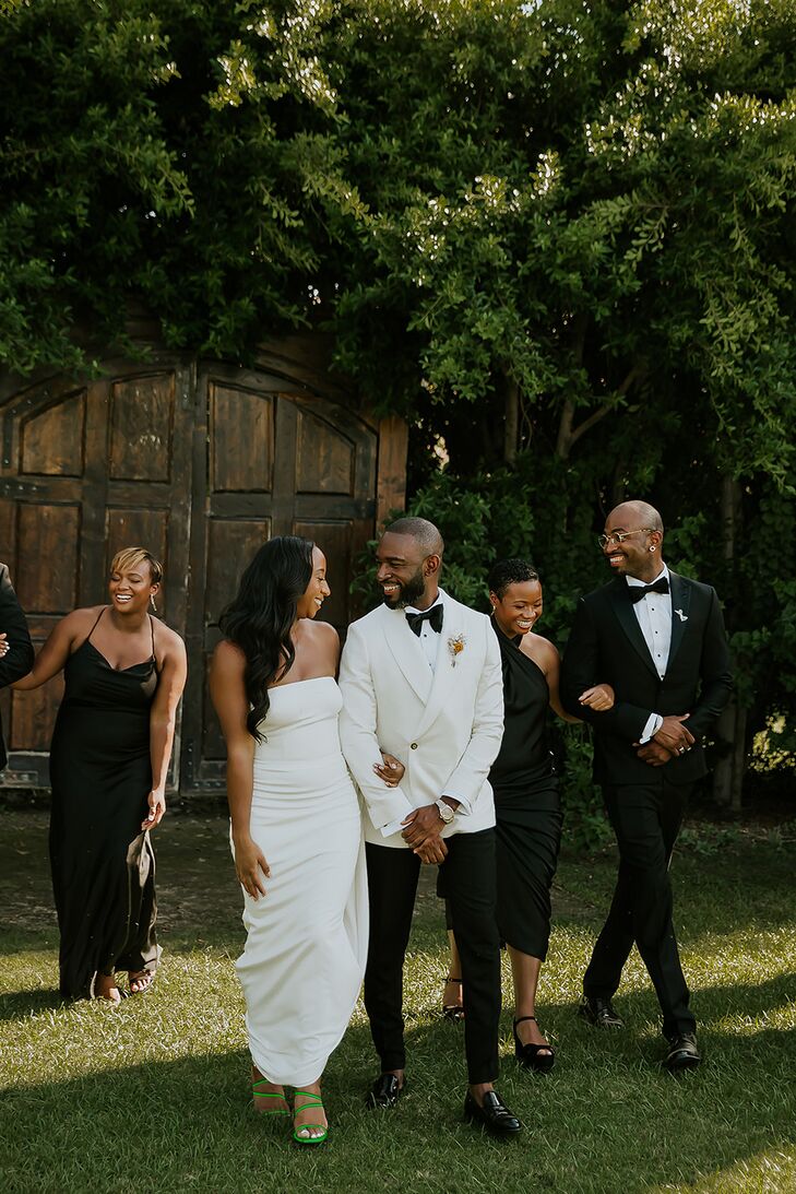 Bride in Simple, Modern, Sleek Gown With Groom in White Tux Jacket and Wedding Party in Black
