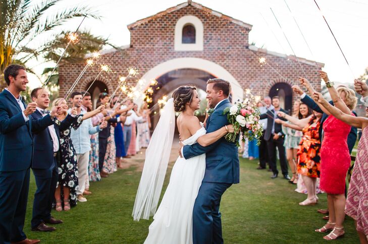 Friends and family lit sparklers to illuminate the couple’s grand entrance. “We were introduced for the first time to our favorite rap song, which was hilarious. Everyone lined up, and we danced our way to the end, all while laughing hysterically,” Taylor says.