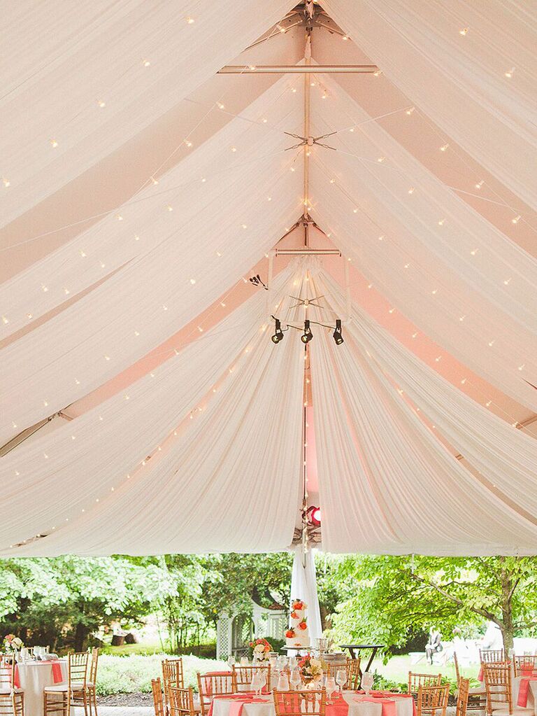 Classic wedding tent with draped ceiling and string lights